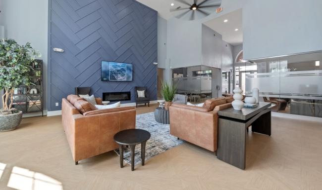 a clubroom with a tv, couches and a table