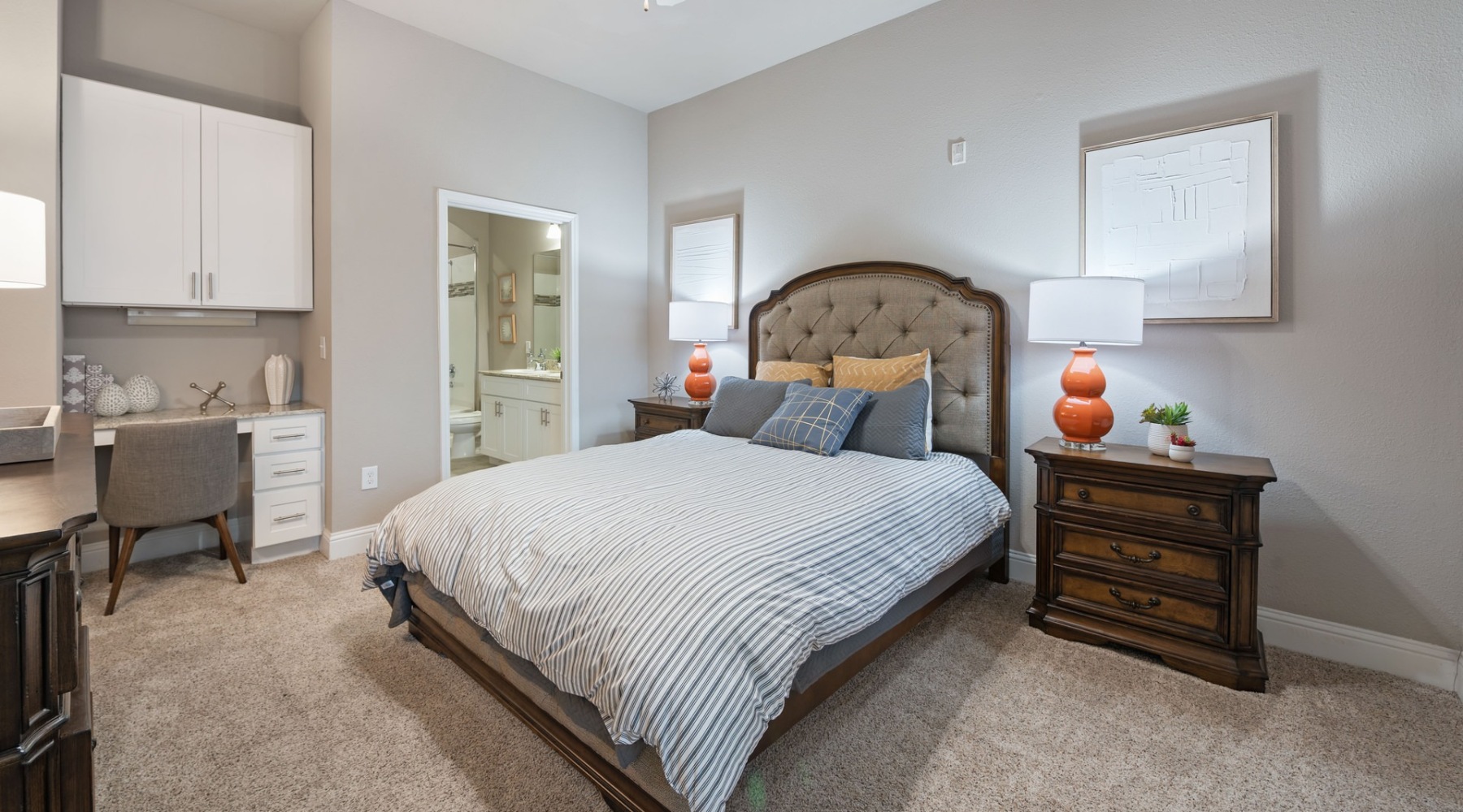 a bedroom with a bed, desk and a chair