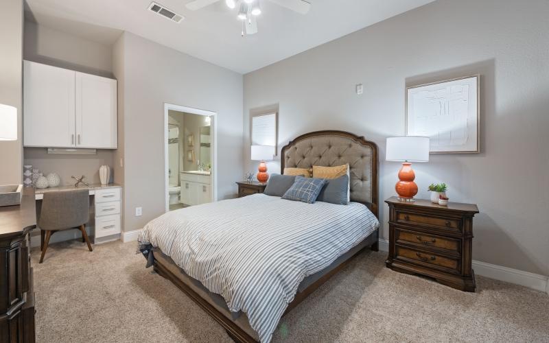 a bedroom with a bed and a chair