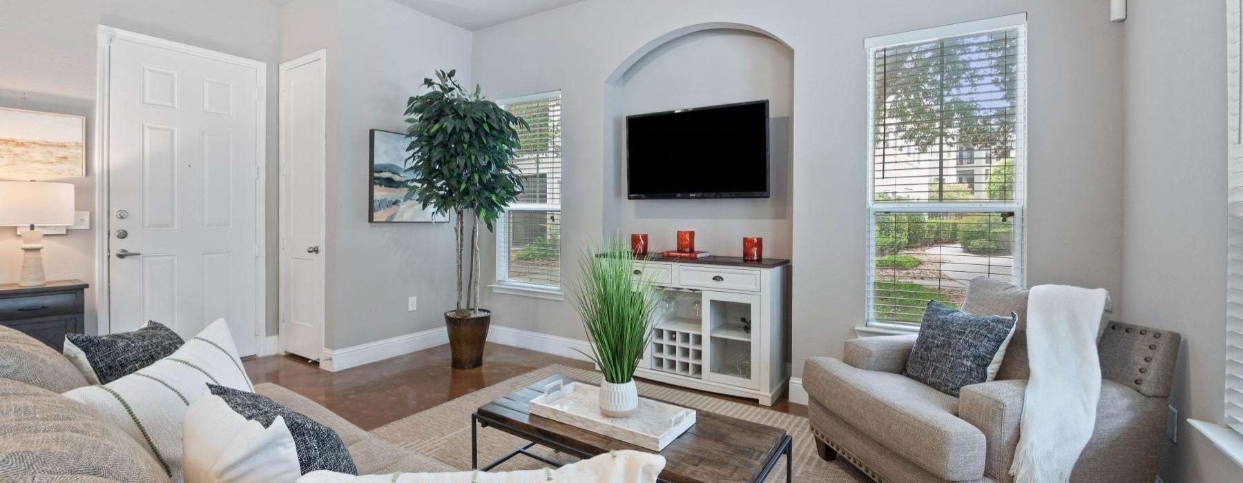 a living room with a tv, couch and a chair